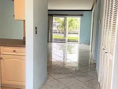 a view of a small space with wooden floor and a window