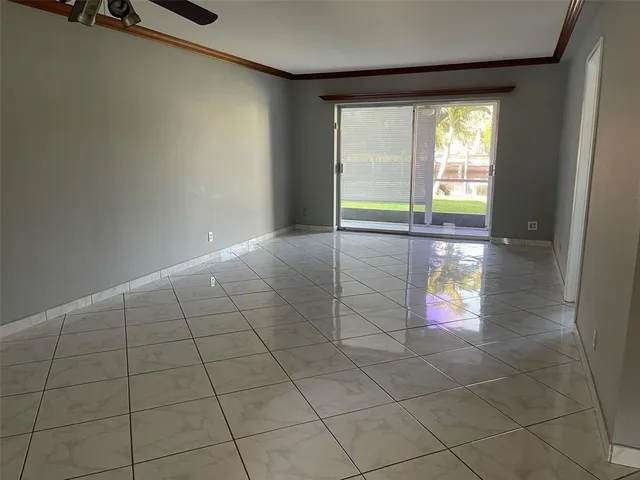 an empty room with floor to ceiling windows and yard