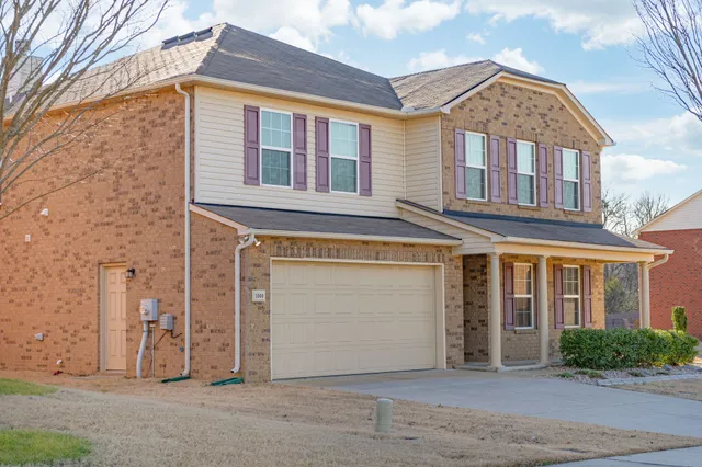 a view of a brick house with many windows