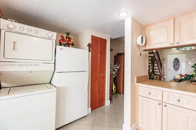 a white refrigerator freezer sitting inside of a kitchen