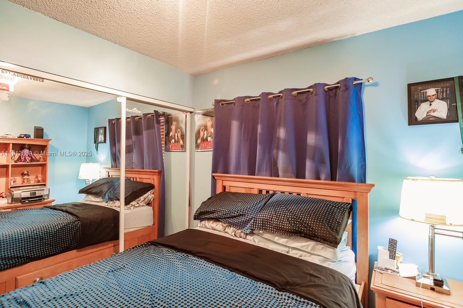 2670 West 60th Street, Unit 90 Hialeah, FL 33016 - Photo 18 of 26 a bedroom with a bed and a dresser