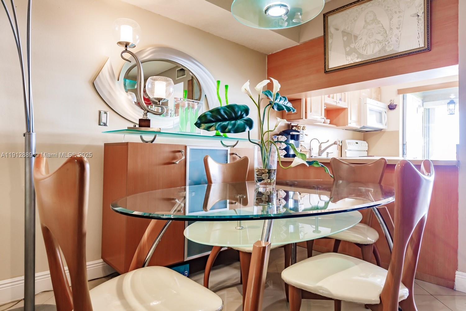 2670 West 60th Street, Unit 90 Hialeah, FL 33016 - Photo 7 of 26 a view of a dining room with furniture and a chandelier