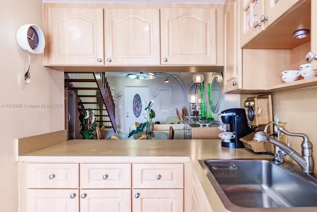 a kitchen with granite countertop a sink and cabinets