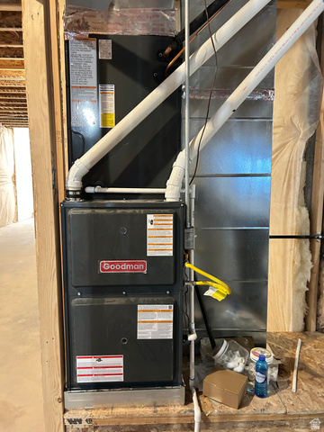 6 South 450th West Gunnison, UT 84634 - Photo 40 of 45 Goodman furnace unit with white PVC piping and exposed wooden framing