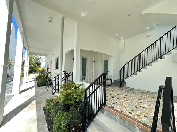 a view of staircase with wooden floor and windows