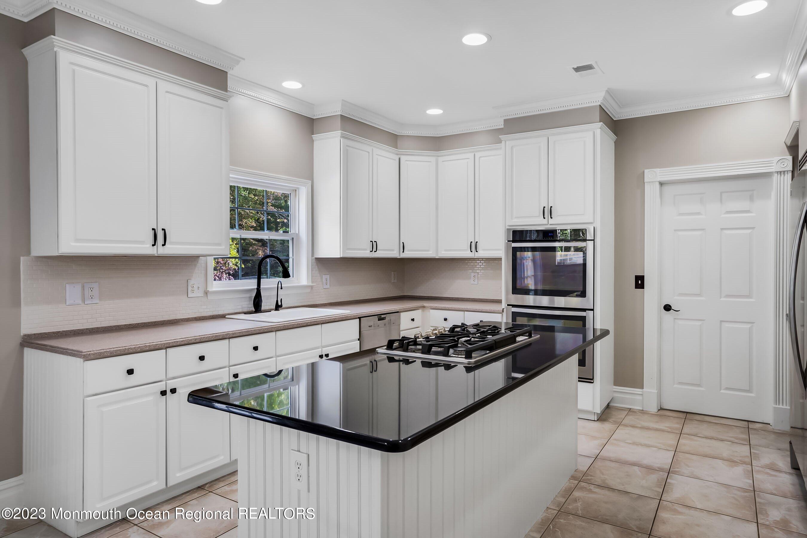 3 Copperleaf Lane Colts Neck, NJ 07722 - Photo 19 of 47 a kitchen with stainless steel appliances granite countertop a stove a sink and a refrigerator