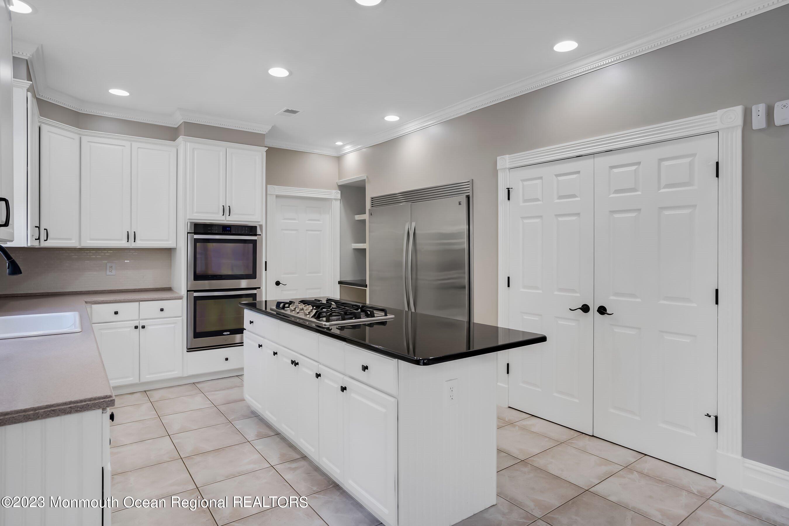 3 Copperleaf Lane Colts Neck, NJ 07722 - Photo 20 of 47 a kitchen with stainless steel appliances a stove a sink and a refrigerator with white cabinets