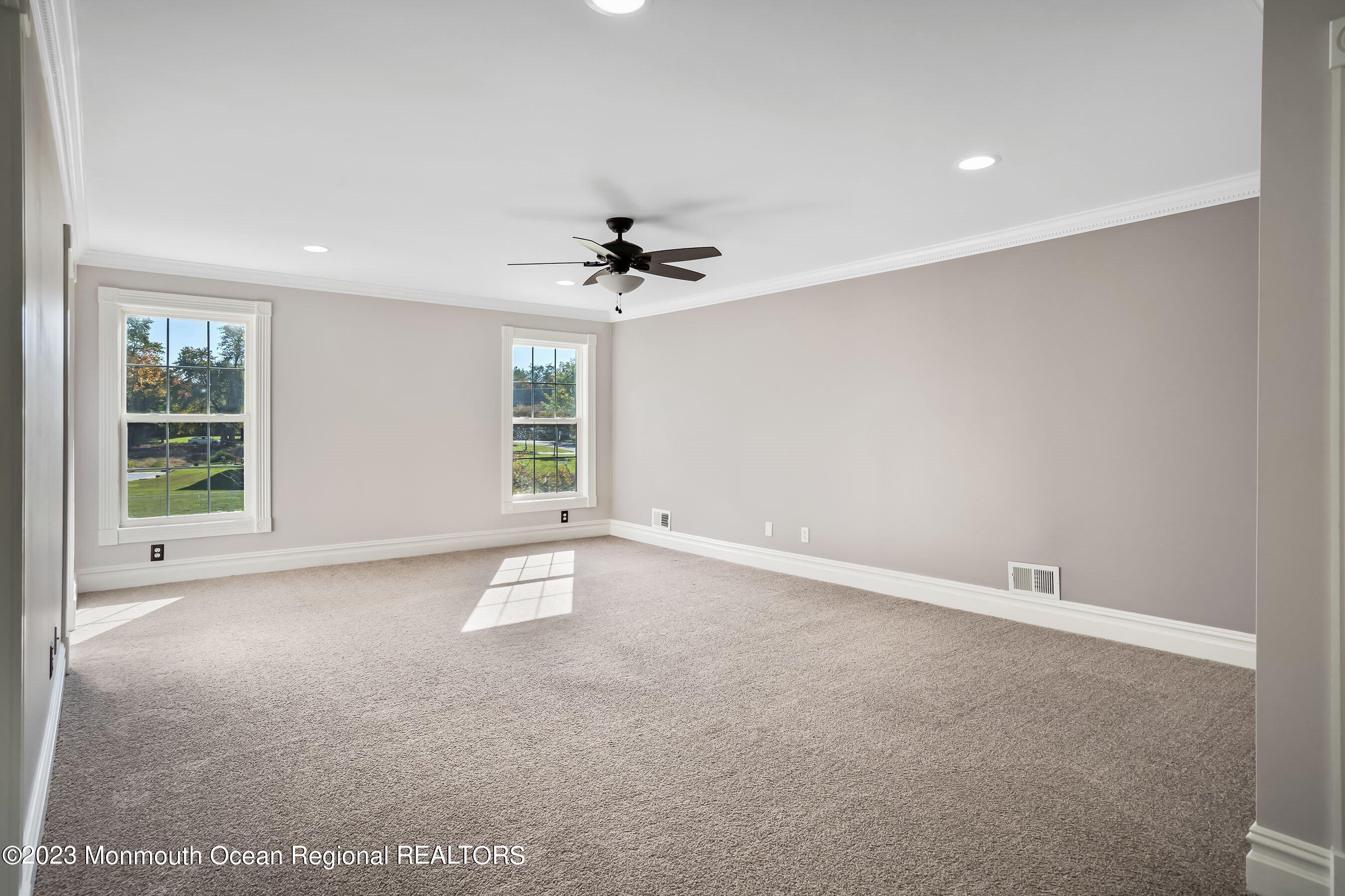 3 Copperleaf Lane Colts Neck, NJ 07722 - Photo 27 of 47 an empty room with windows and ceiling fan