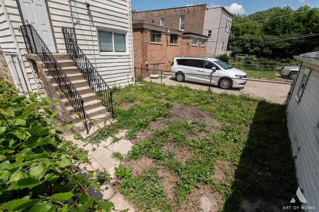 a white car parked in front of a house