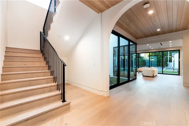 a view of an empty room with a floor to ceiling window and stairs