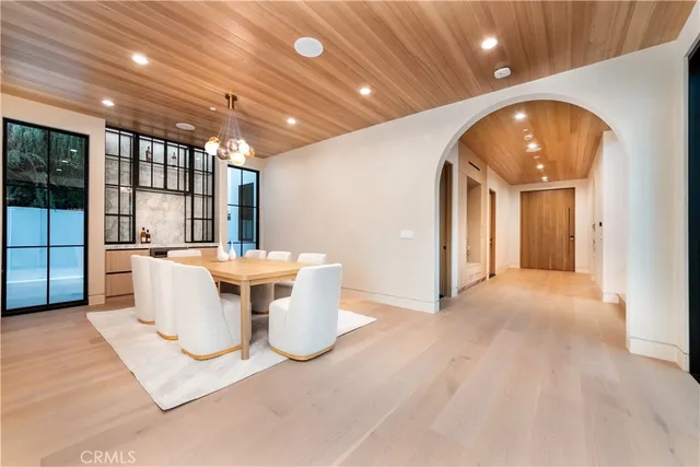 a view of a big room with kitchen and chandelier