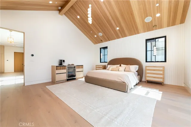 a bedroom with a large bed and a large window