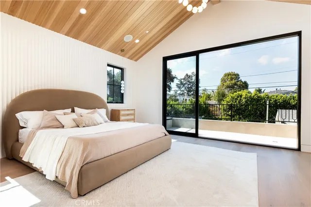 a bedroom with a large bed and a large window