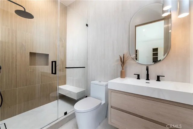 a bedroom with a bed and large mirror