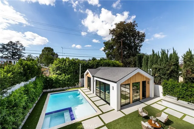a view of a house with a yard patio and fire pit