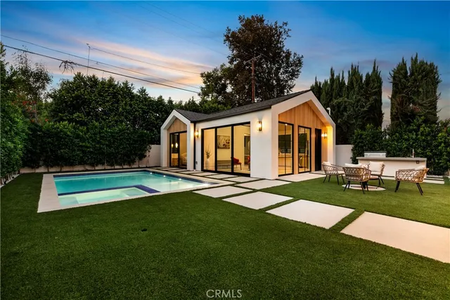 a living room with furniture and kitchen view