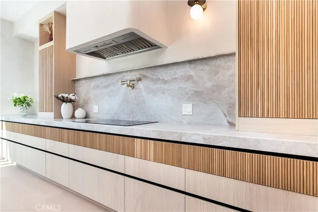 a kitchen with a sink and wooden floor