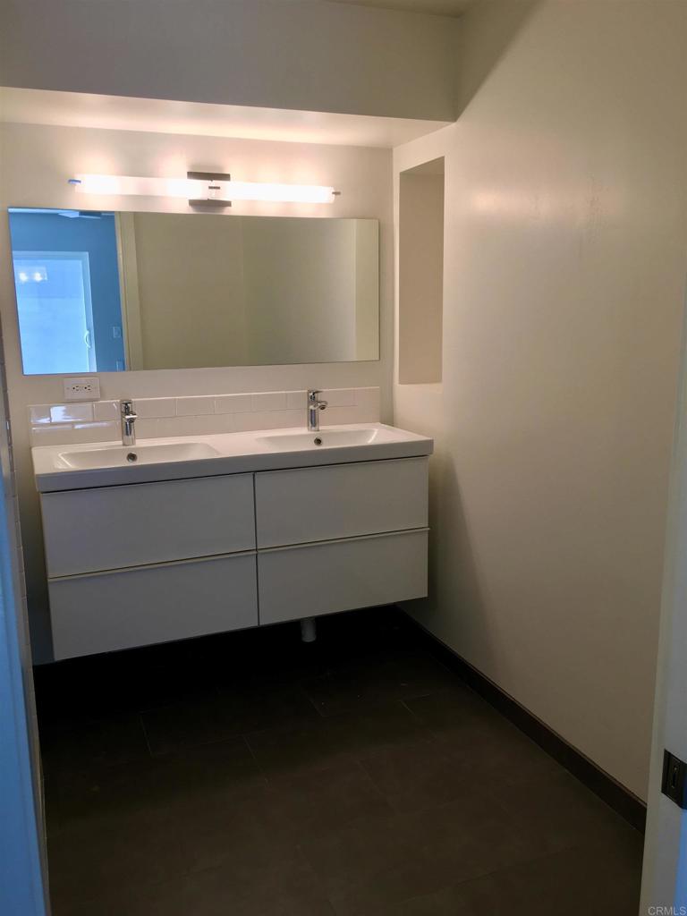 148 Europa Street Encinitas, CA 92024 - Photo 14 of 23 a bathroom with a double vanity sink and mirror