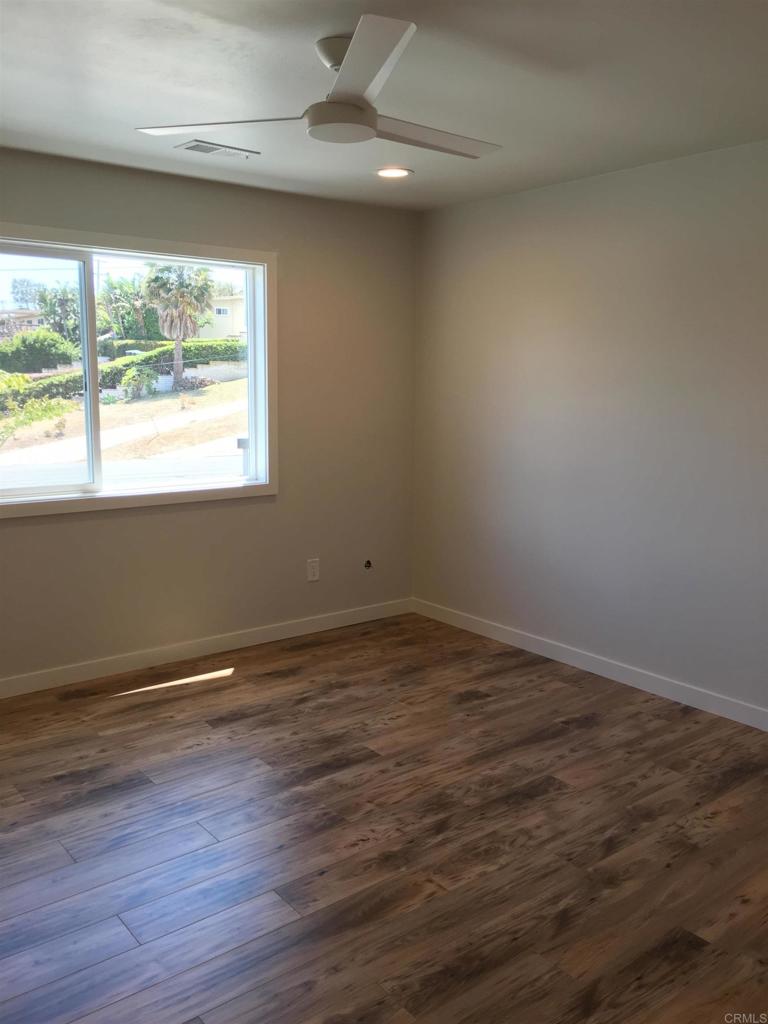 148 Europa Street Encinitas, CA 92024 - Photo 16 of 23 an empty room with wooden floor and windows