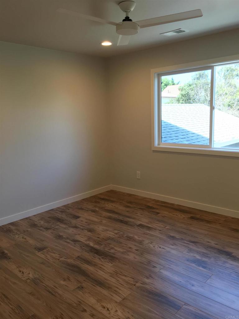 148 Europa Street Encinitas, CA 92024 - Photo 18 of 23 a view of an empty room with wooden floor and a window