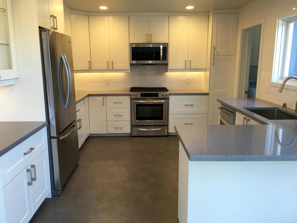 148 Europa Street Encinitas, CA 92024 - Photo 7 of 23 a kitchen with a refrigerator and a stove