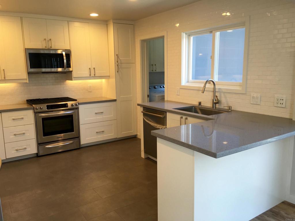 148 Europa Street Encinitas, CA 92024 - Photo 8 of 23 a kitchen with stainless steel appliances granite countertop a sink a stove and a refrigerator