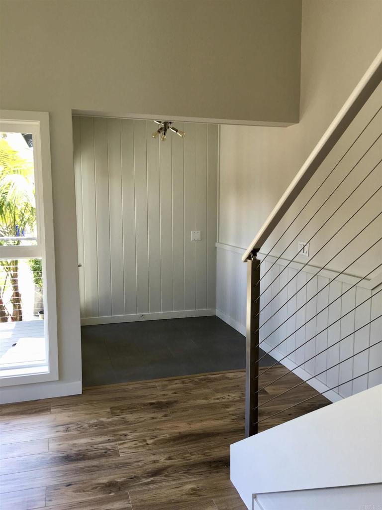 148 Europa Street Encinitas, CA 92024 - Photo 9 of 23 a view of a hallway with wooden floor and staircase