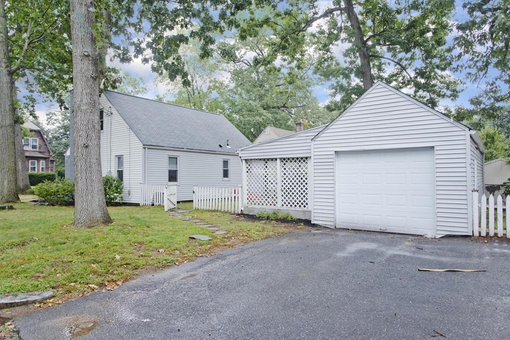 228 Shawmut Street Springfield, MA 01108 - Photo 37 of 39 a front view of a house with a yard and garage