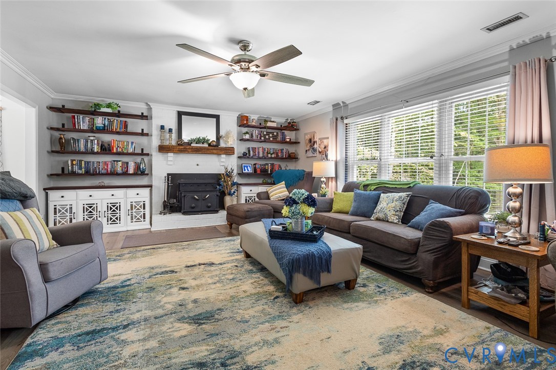 212 Copper Line Road Bumpass, VA 23024 - Photo 13 of 35 a living room with furniture a fireplace and a large window