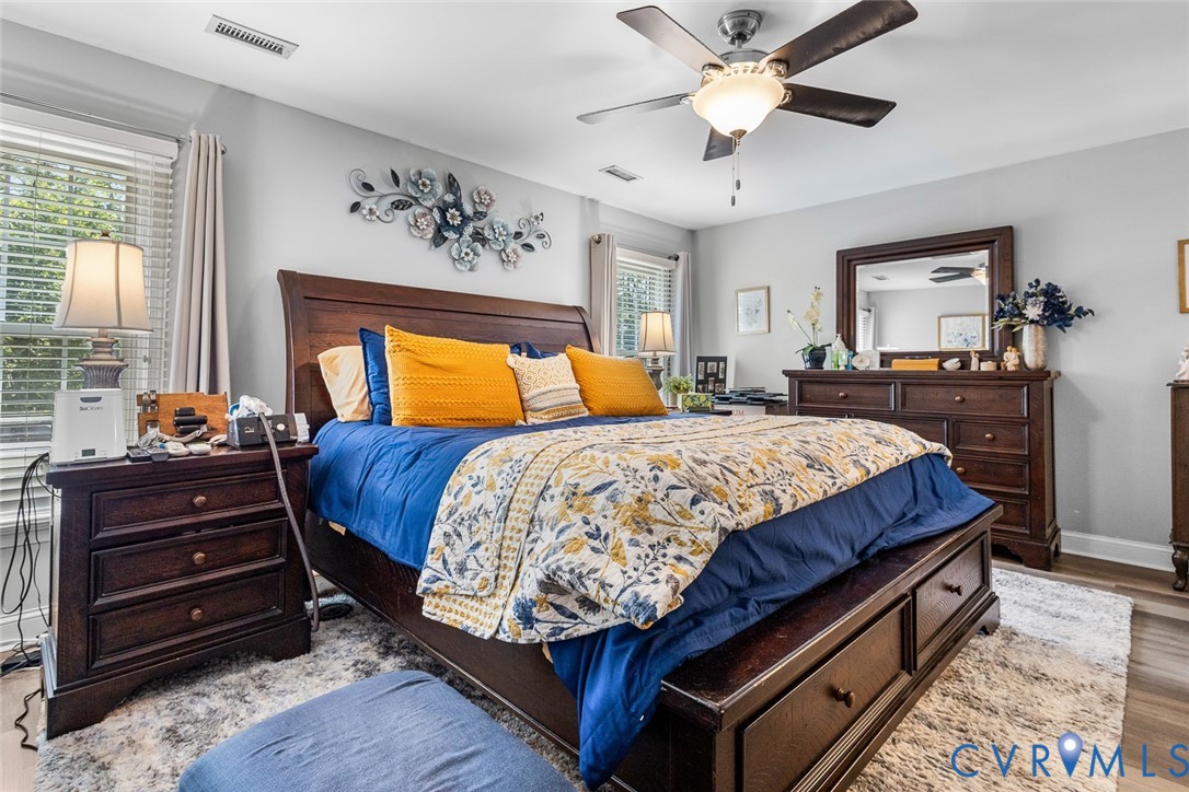 212 Copper Line Road Bumpass, VA 23024 - Photo 14 of 35 a bedroom with a bed and wooden floor