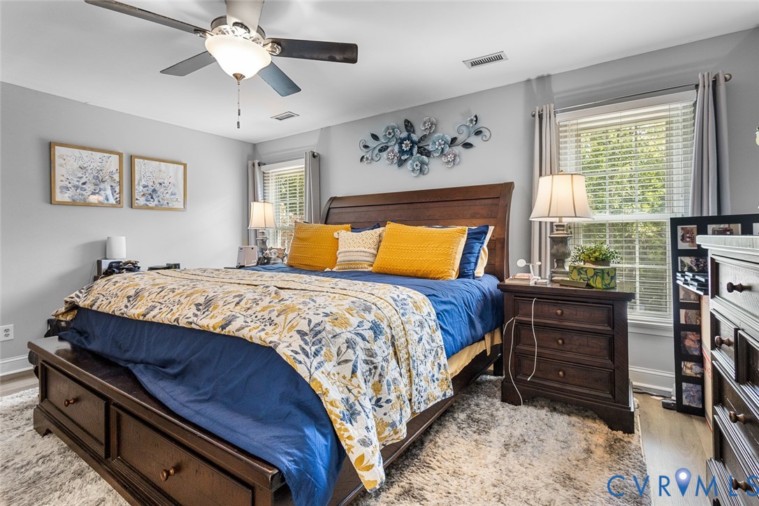 212 Copper Line Road Bumpass, VA 23024 - Photo 15 of 35 a bedroom with a bed and a chandelier