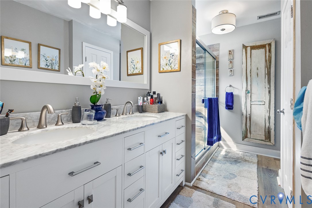 212 Copper Line Road Bumpass, VA 23024 - Photo 16 of 35 a bathroom with a granite countertop sink mirror and vanity