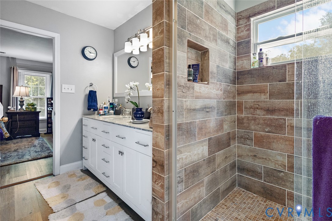 212 Copper Line Road Bumpass, VA 23024 - Photo 17 of 35 a bathroom with a mirror and a shower