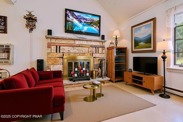 a living room with furniture a rug and a large window