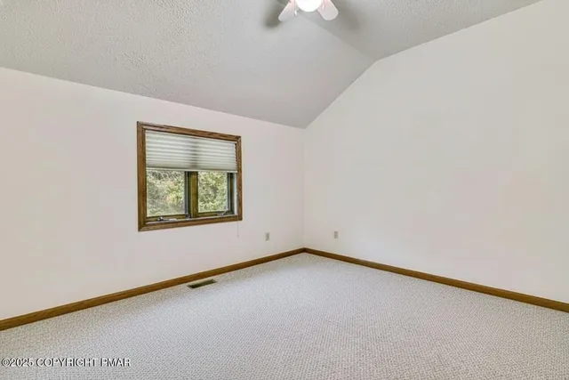 a kitchen with stainless steel appliances granite countertop white cabinets and a counter top space