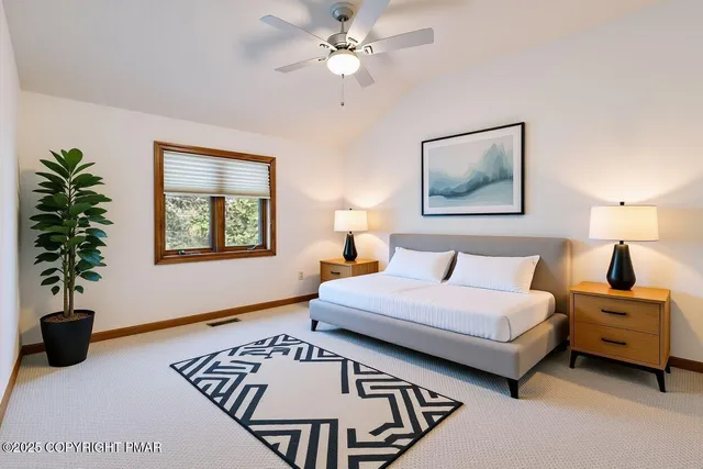 a view of a refrigerator in kitchen and an empty room