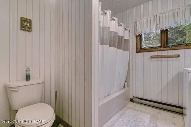 a view of a bench in the backyard of the house