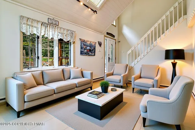 a kitchen with refrigerator and chairs