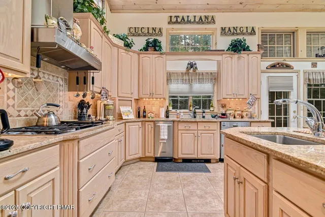 a dining hall with stainless steel appliances a table and chairs with the wooden floor