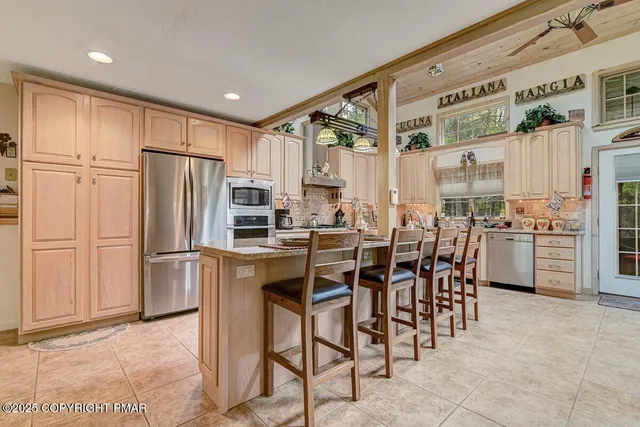 a spacious bedroom with a bed a couch and a window