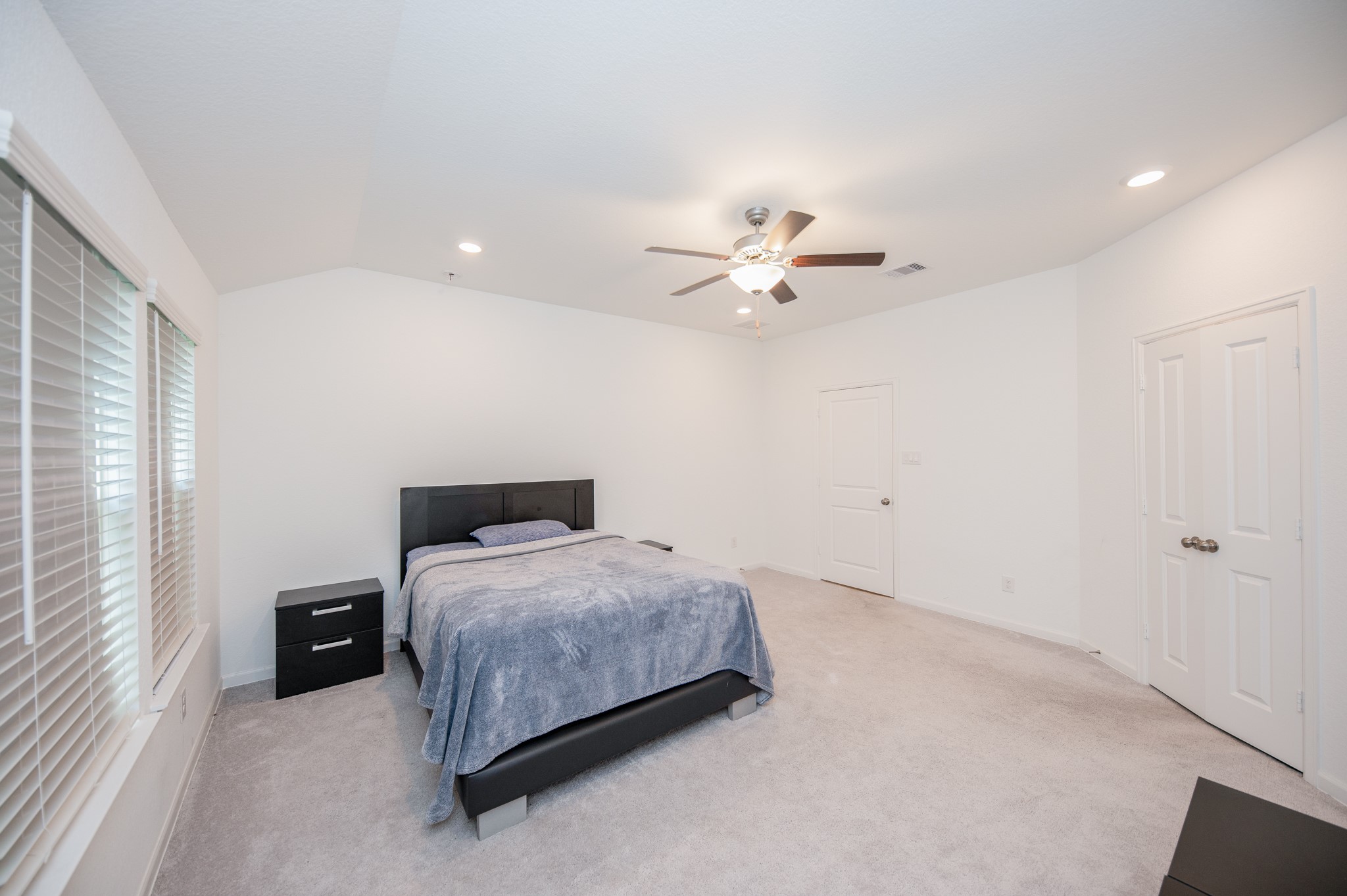 3634 Homestead Ridge Lane Richmond, TX 77406 - Photo 14 of 32 a bedroom with a bed and a chandelier