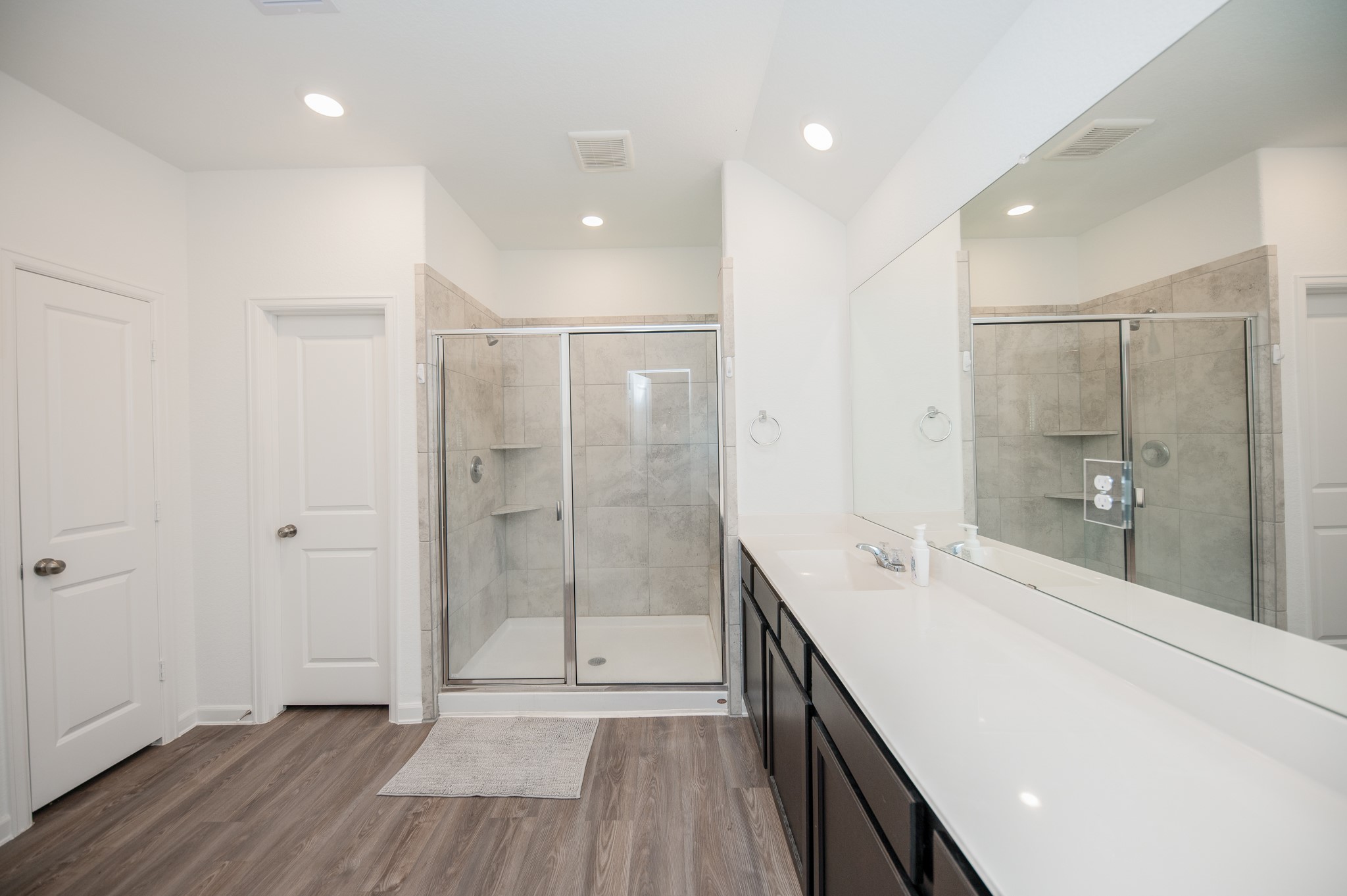 3634 Homestead Ridge Lane Richmond, TX 77406 - Photo 17 of 32 a spacious bathroom with a shower a sink a mirror and a shower