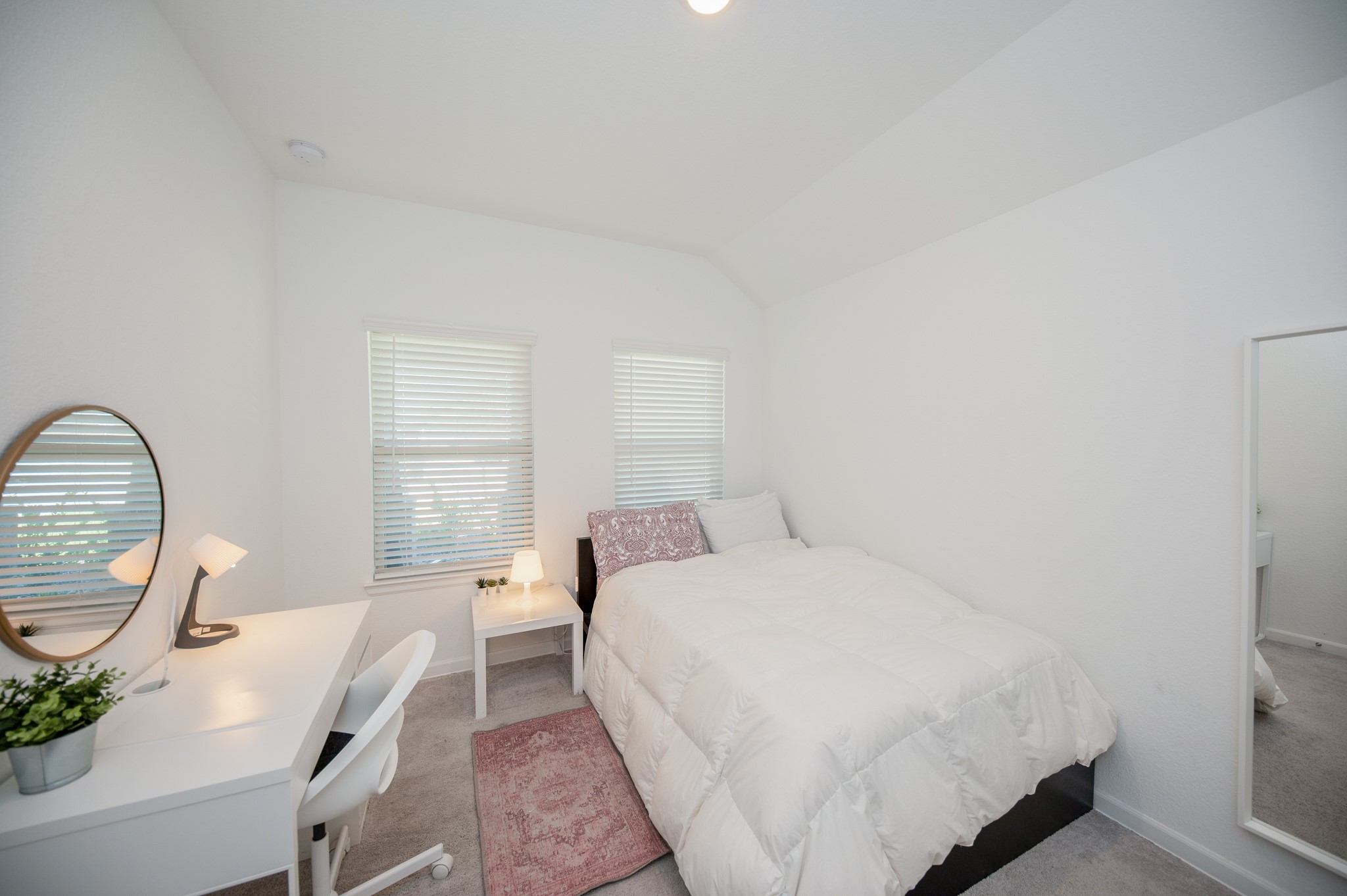 3634 Homestead Ridge Lane Richmond, TX 77406 - Photo 21 of 32 a bedroom with a bed a table and a large window