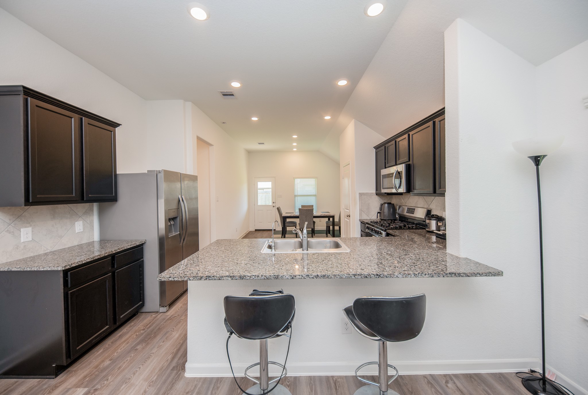 3634 Homestead Ridge Lane Richmond, TX 77406 - Photo 7 of 32 a kitchen with stainless steel appliances granite countertop a sink a stove a refrigerator and cabinets