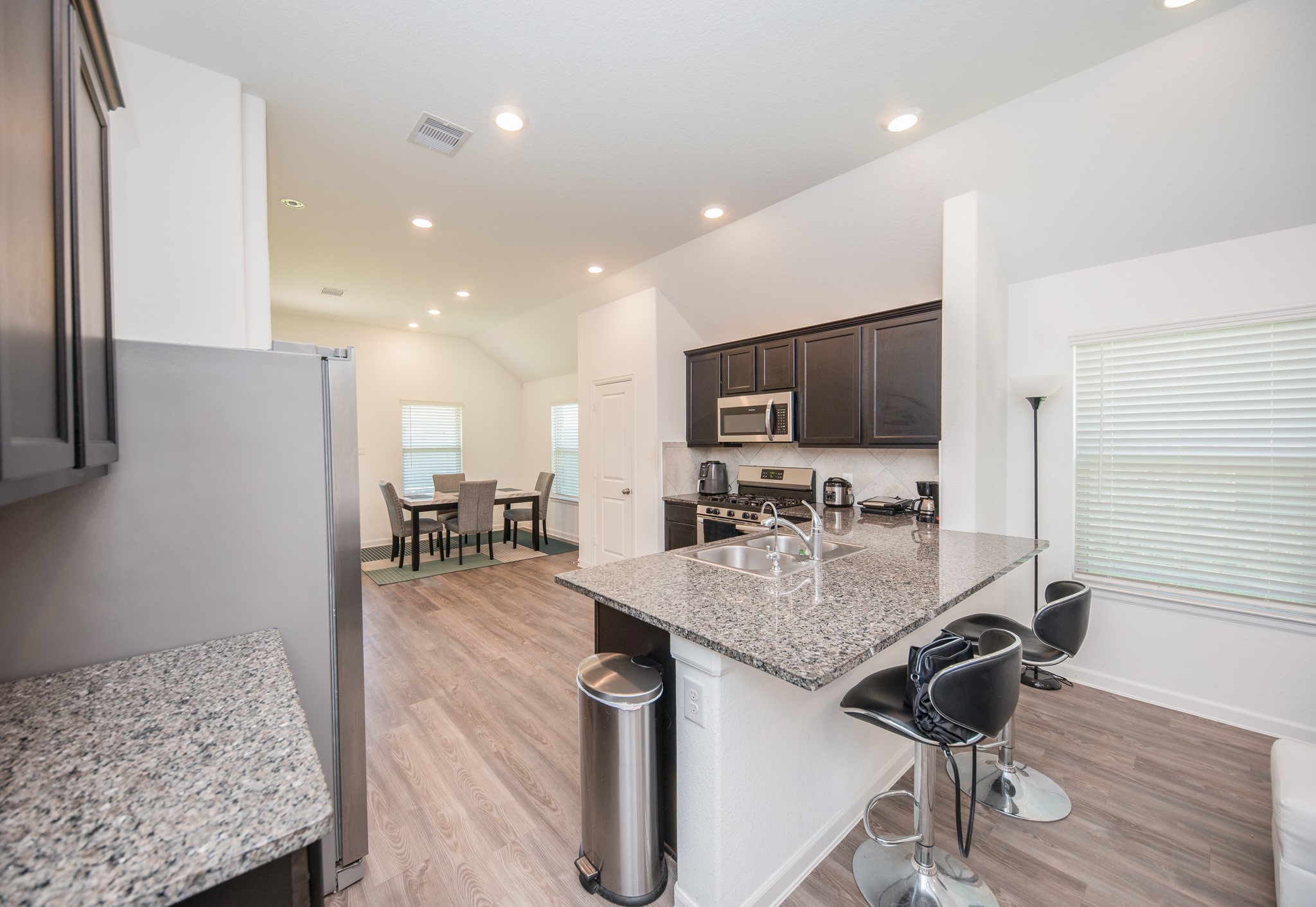 3634 Homestead Ridge Lane Richmond, TX 77406 - Photo 8 of 32 a kitchen with stainless steel appliances granite countertop a sink stove and refrigerator