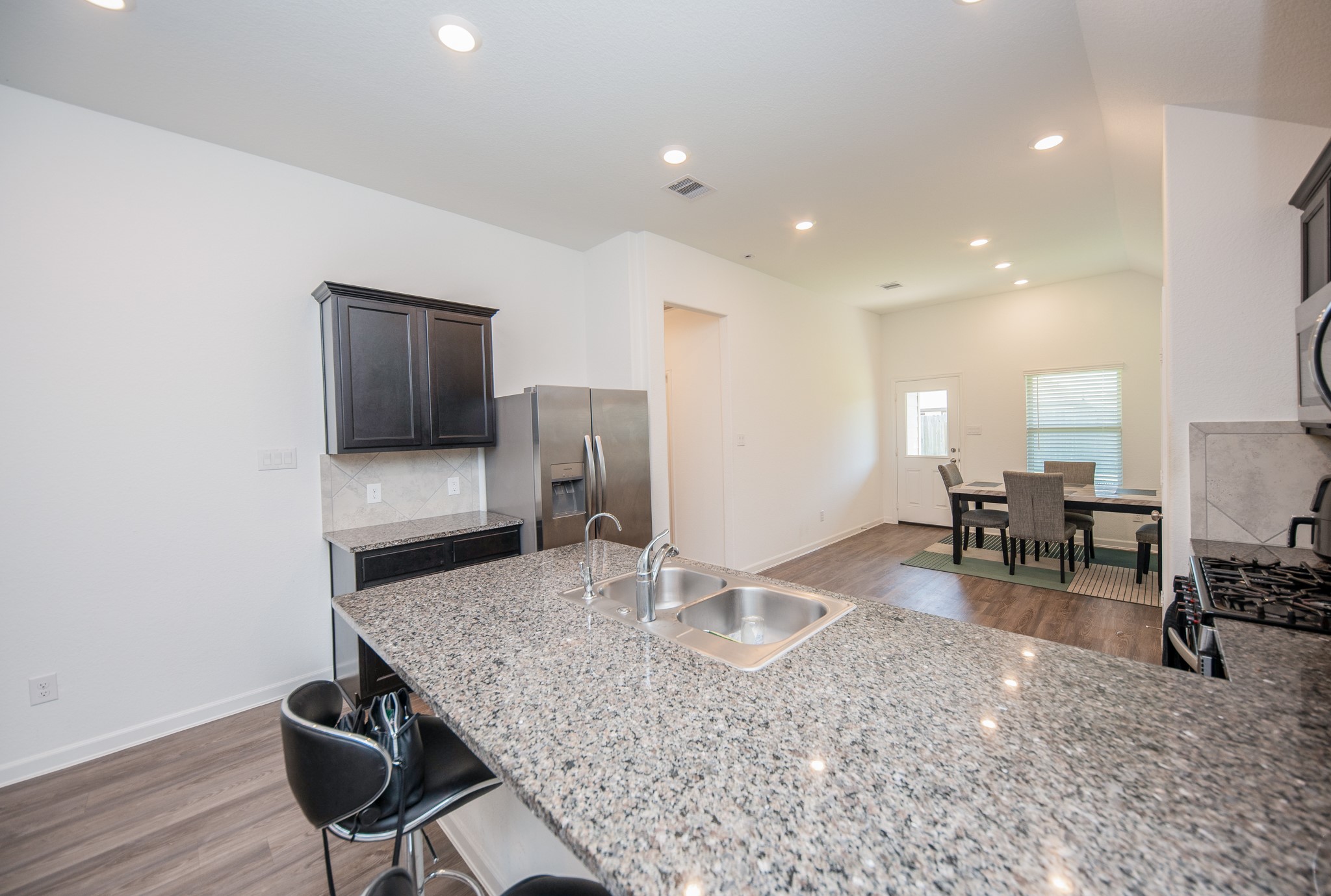 3634 Homestead Ridge Lane Richmond, TX 77406 - Photo 9 of 32 a kitchen with stainless steel appliances kitchen island granite countertop a sink and cabinets