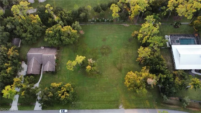 an aerial view of a house with a yard basket ball court and outdoor seating