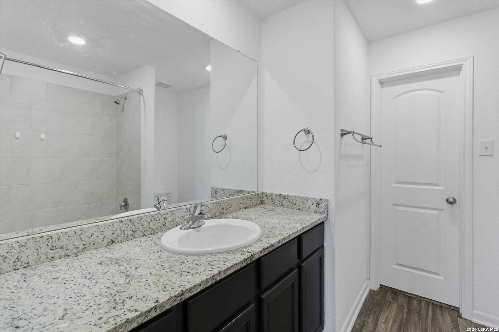 3130 Jackson Converse, TX 78109 - Photo 19 of 22 a bathroom with a granite countertop sink a mirror and shower
