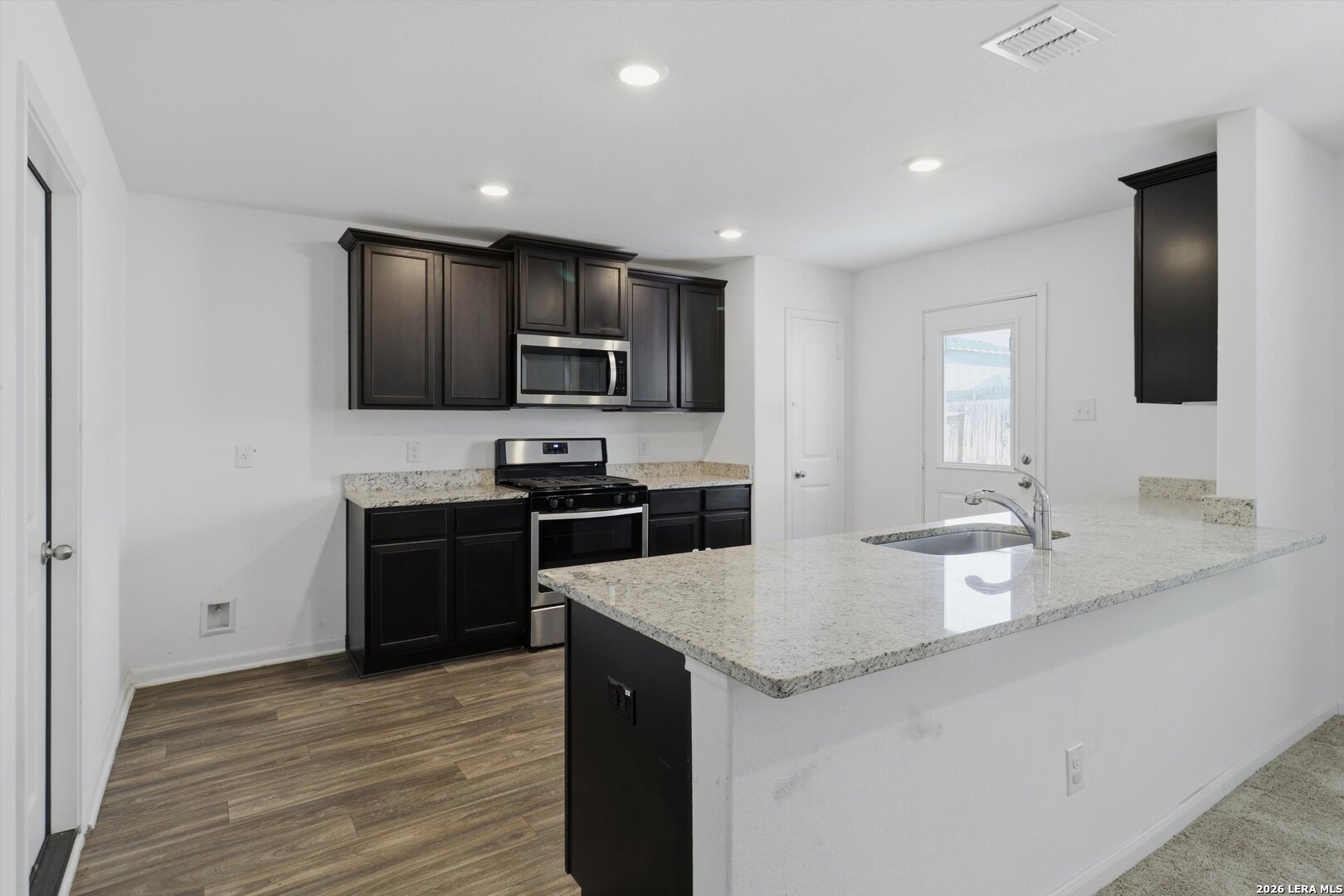 3130 Jackson Converse, TX 78109 - Photo 9 of 22 a large kitchen with granite countertop a large counter top space appliances and cabinets