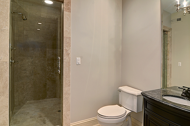 3011 Lincoln Road Oak Brook, IL 60523 - Photo 45 of 77 a white toilet sitting next to a bathroom sink